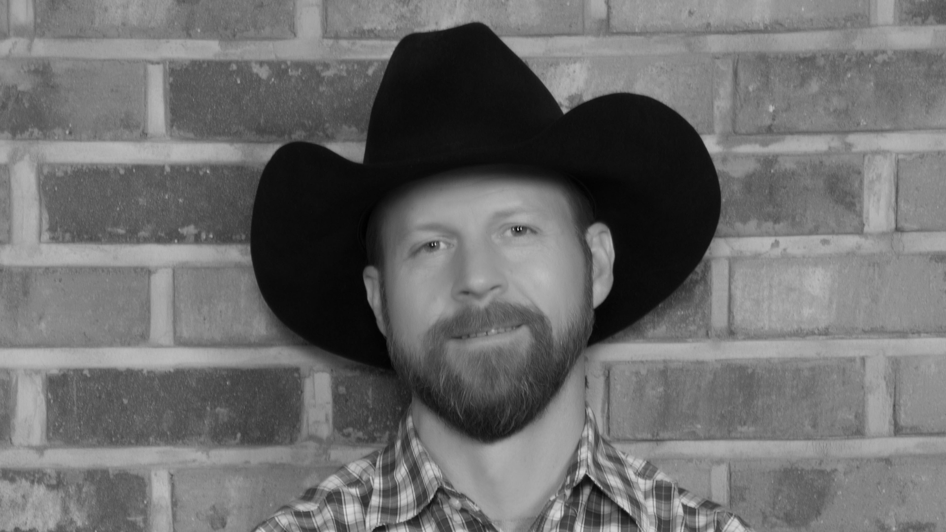 Black and white rendering of a bearded man in a cowboy hat