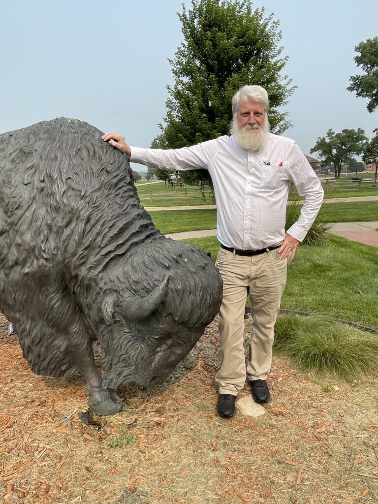 Rich Pope with bison statue