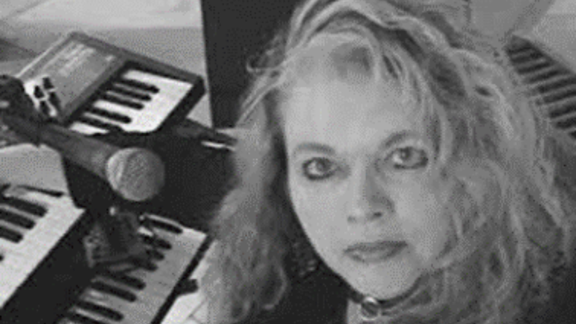 Black and white ohoto of woman in front of a keyboard